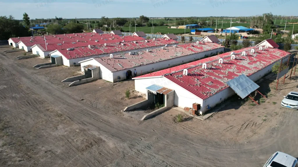 Parallel red-roofed buildings with open access areas around the site.