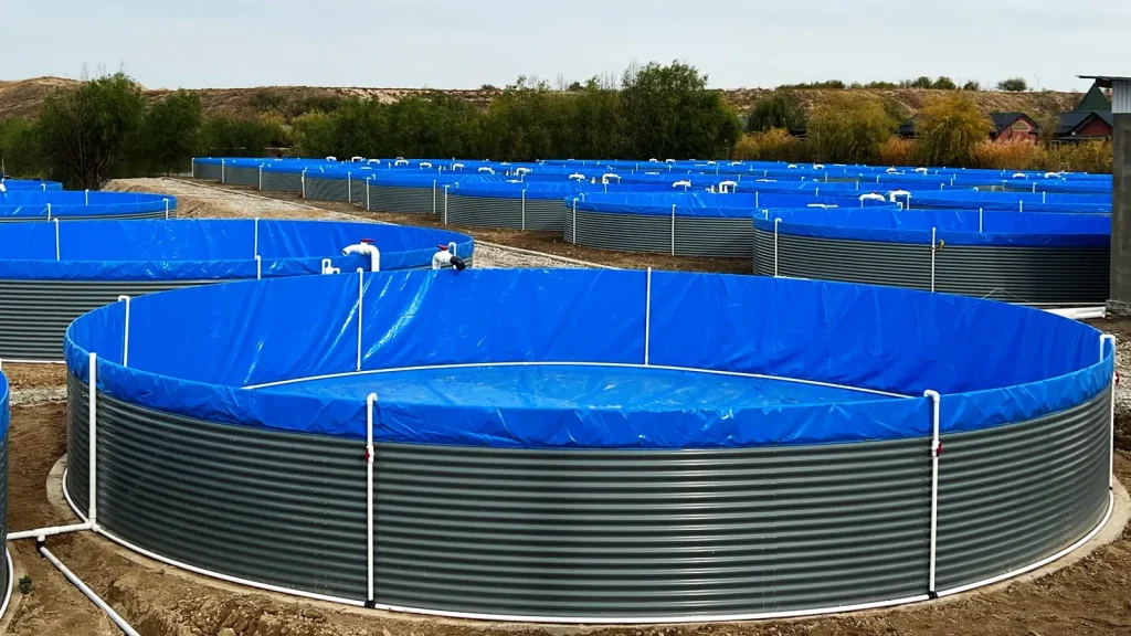Blue-lined circular tanks with corrugated outer walls and white pipework.