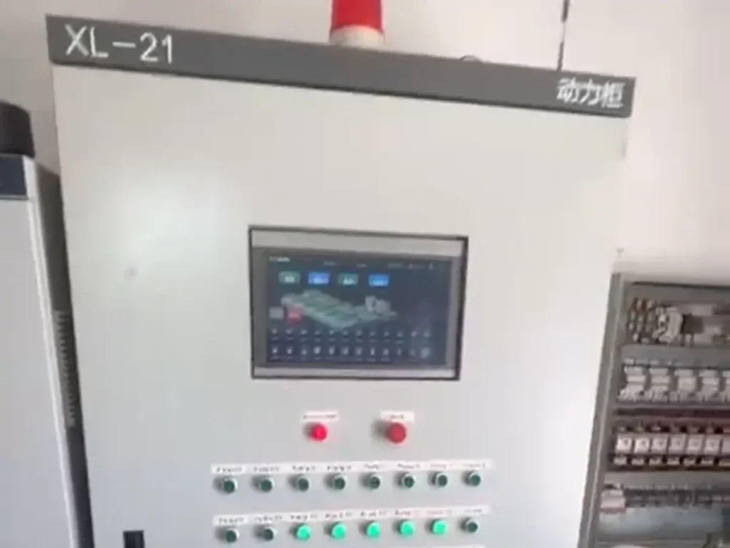 Electrical control cabinet with a touchscreen, indicator lights and rows of push buttons.